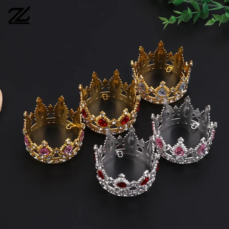 A collection of five gold and silver tiara crowns used as cake toppers or hair accessories.