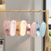 A row of soft, fuzzy silicone shoe organizers in various pastel colors are hanging from a wooden rod.