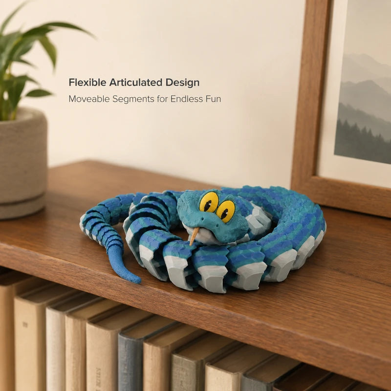 A blue and gray flexible articulated snake desk toy with a head resting on a wooden surface.