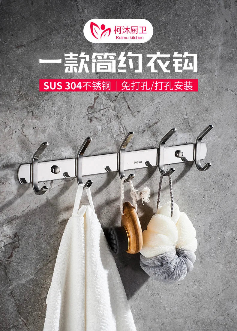 A set of six polished stainless steel wall-mounted hooks is displayed against a gray concrete background.