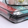 A transparent waterproof toiletry bag with a black zipper, containing various cosmetic products.