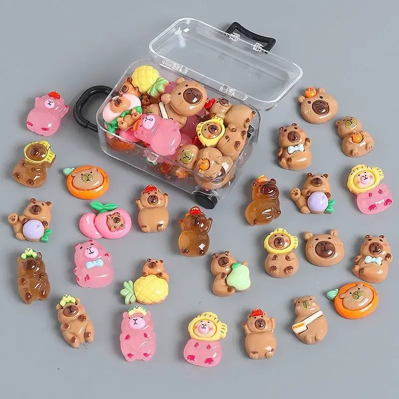 A clear plastic suitcase contains several small, cute capybara-themed figures with soft glow effects.