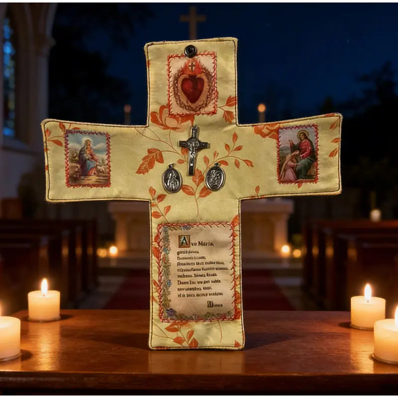 A handcrafted wooden cross with decorative elements and a small prayer card displayed on a dark wooden surface.