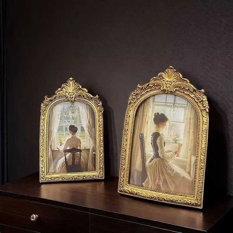 An ornate gold-framed vintage resin photo frame displaying a portrait of a woman.