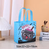 A blue non-woven tote bag featuring a cartoon penguin face design with festive holiday elements.