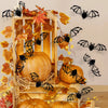 A wooden pumpkin display featuring black bat wall decals and autumn leaves.