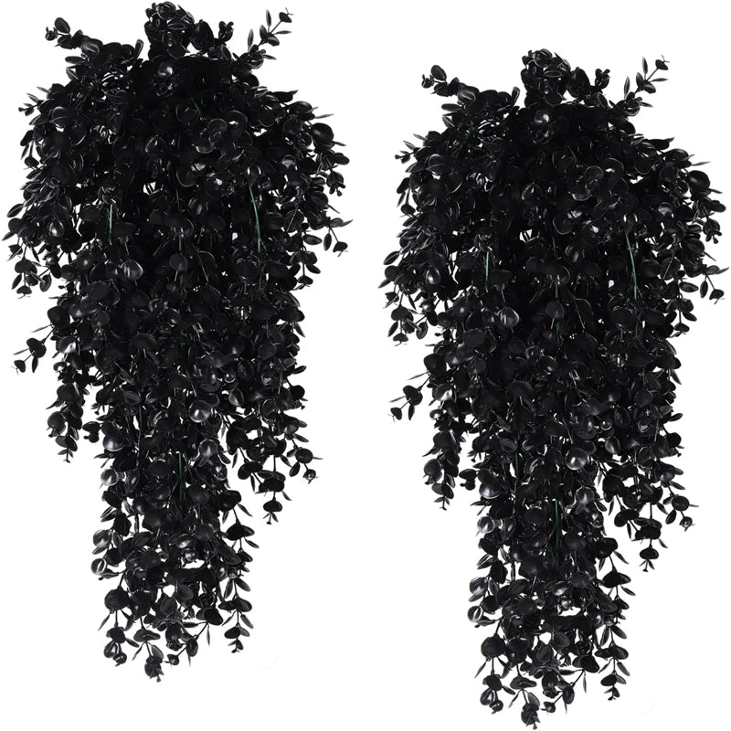 A pair of artificial eucalyptus leaf faux plants used for home decor.