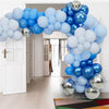 An archway decorated with a large balloon garland featuring metallic chrome and light blue balloons.