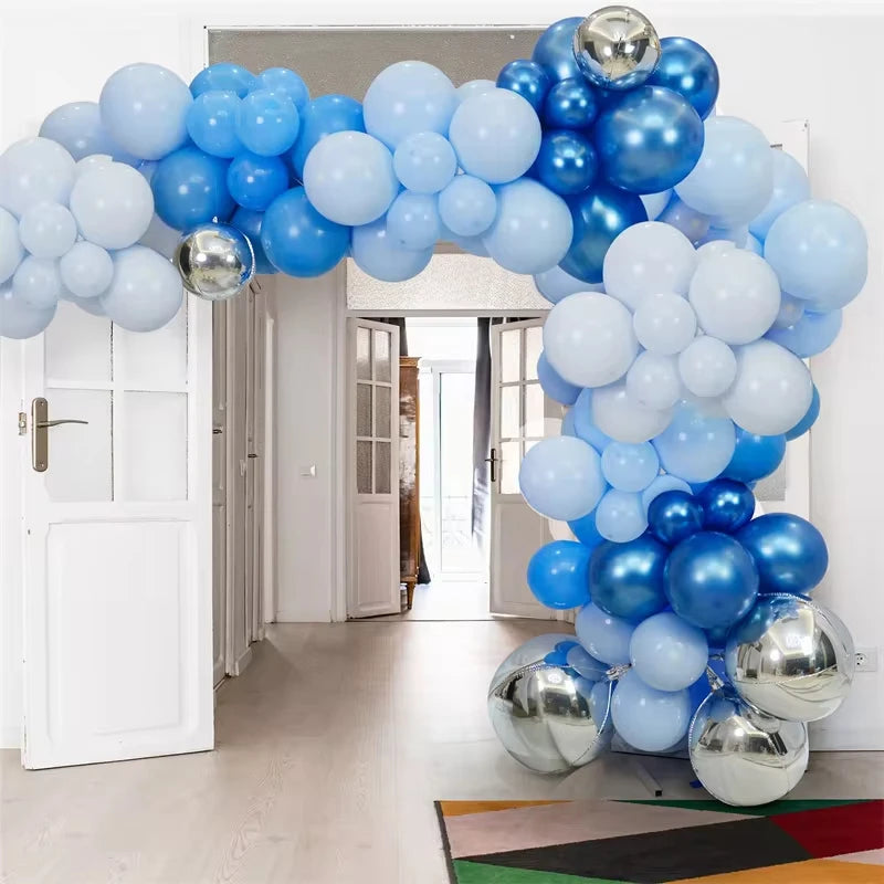 An archway decorated with a large balloon garland featuring metallic chrome and light blue balloons.