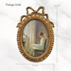 A vintage gold bowknot picture frame with an oval painting of a woman seated.