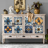 A distressed white wooden cabinet featuring decorative blue and gold floral wall decals.