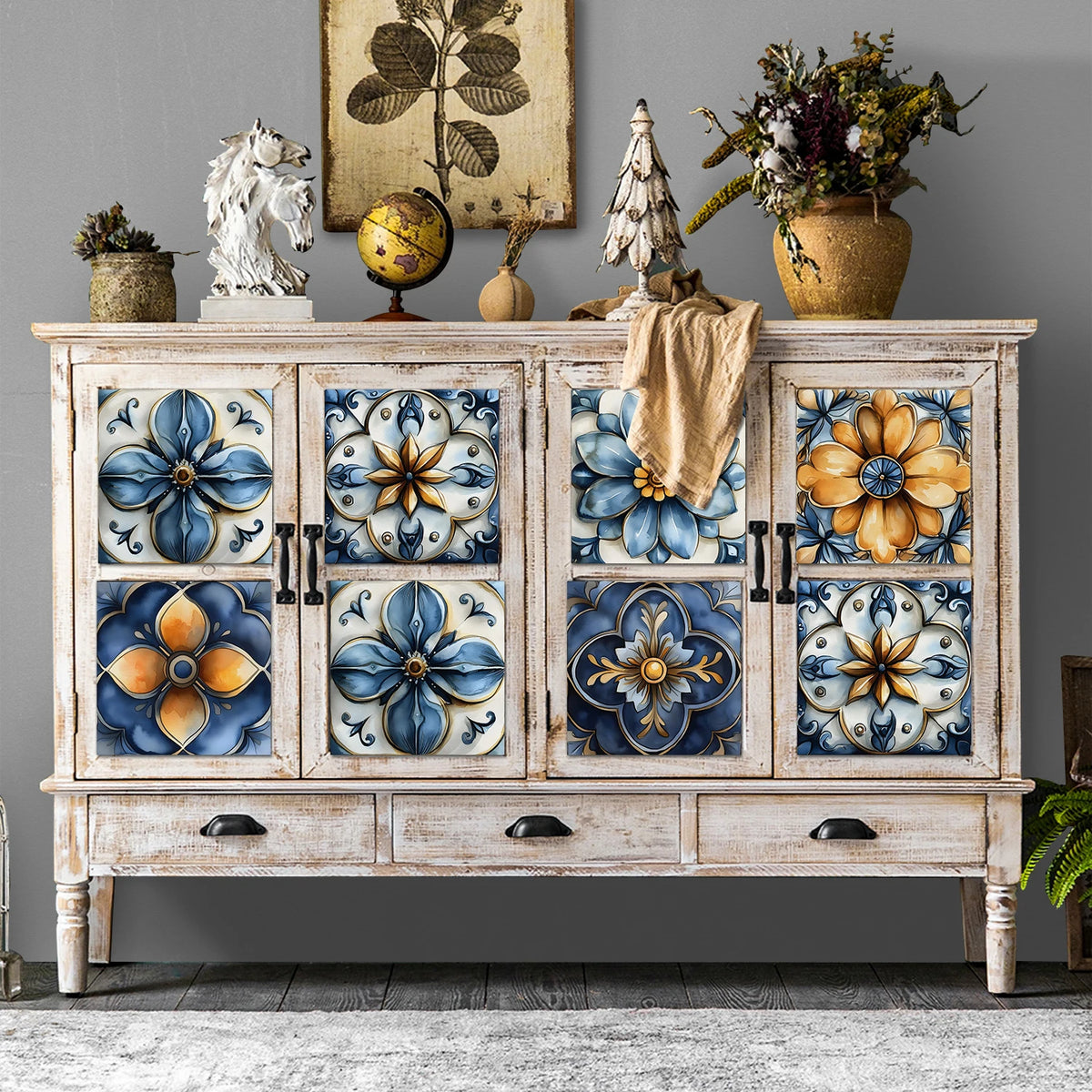 A distressed white wooden cabinet featuring decorative blue and gold floral wall decals.