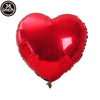 A red heart-shaped foil balloon used for celebrations.