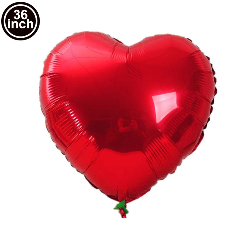 A red heart-shaped foil balloon used for celebrations.
