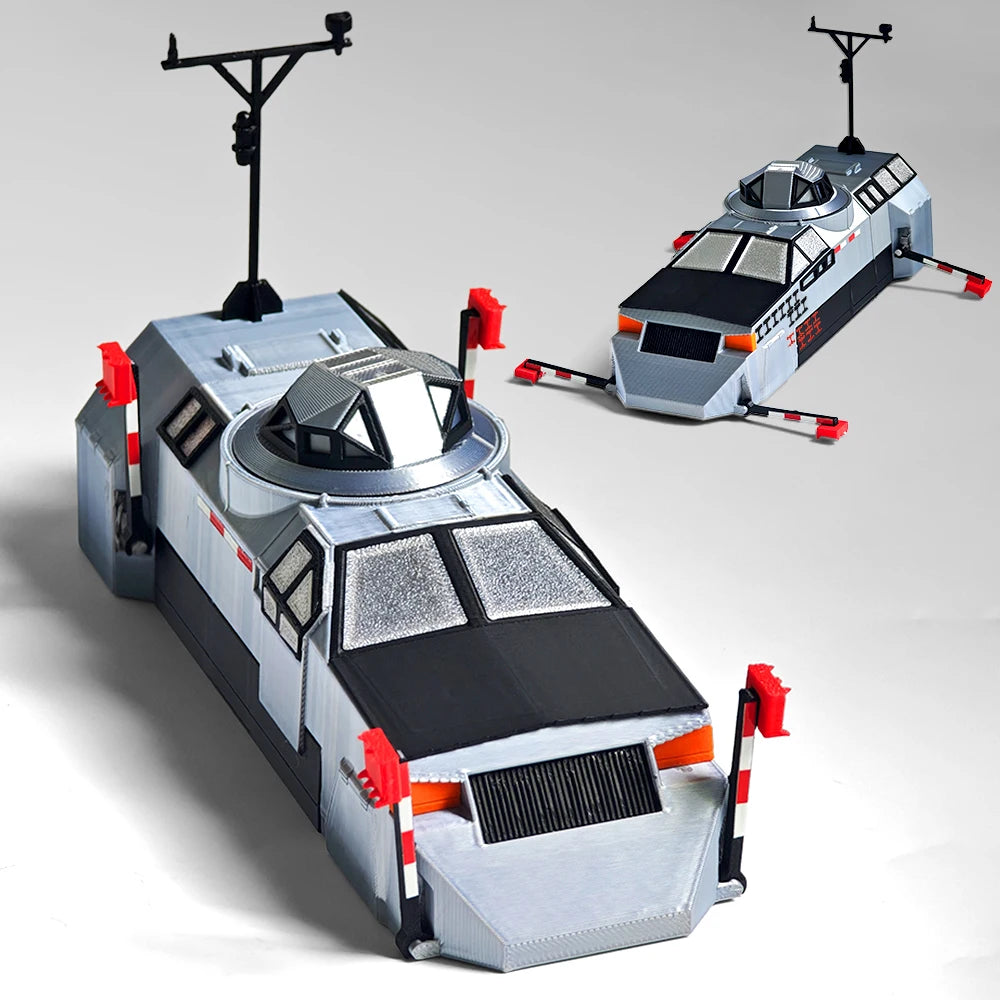 A silver and black 3D printed display model of a Tornado intercept vehicle with external antennae.