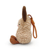 A fluffy beige plush toy resembling a reindeer with brown antlers and an orange scarf.