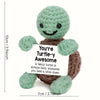 Handmade crochet turtle doll with a smiling face and an inspirational card