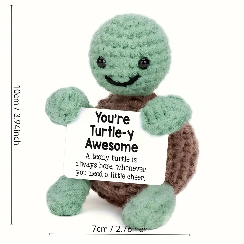 Handmade crochet turtle doll with a smiling face and an inspirational card