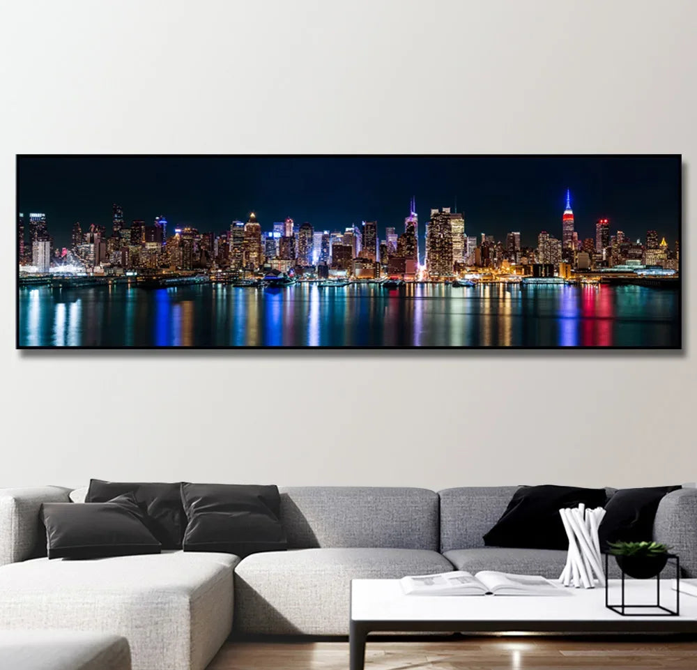 A canvas print of the New York City skyline at night, featuring illuminated skyscrapers reflected on water.