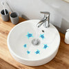 A white ceramic bathroom sink with blue sea turtle decals and a chrome faucet on a wooden counter.