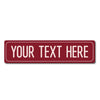 A rectangular red metal street sign with the text YOUR TEXT HERE.
