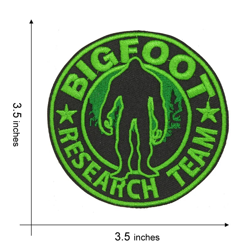 A circular embroidered patch featuring a silhouette of Bigfoot surrounded by the text BIGFOOT RESEARCH TEAM on a black backgr