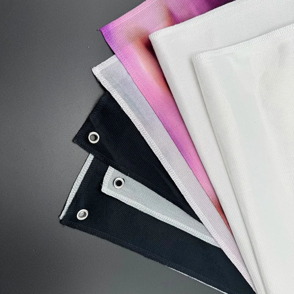 A stack of decorative fabric banners in shades of pink, purple, and white, shown from the side.