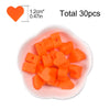 A pile of orange silicone heart beads is displayed in a white dish, with a heart shape dimension marker.