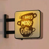 A magnetic fridge decor featuring a glowing sign that reads I Need More Coffee.