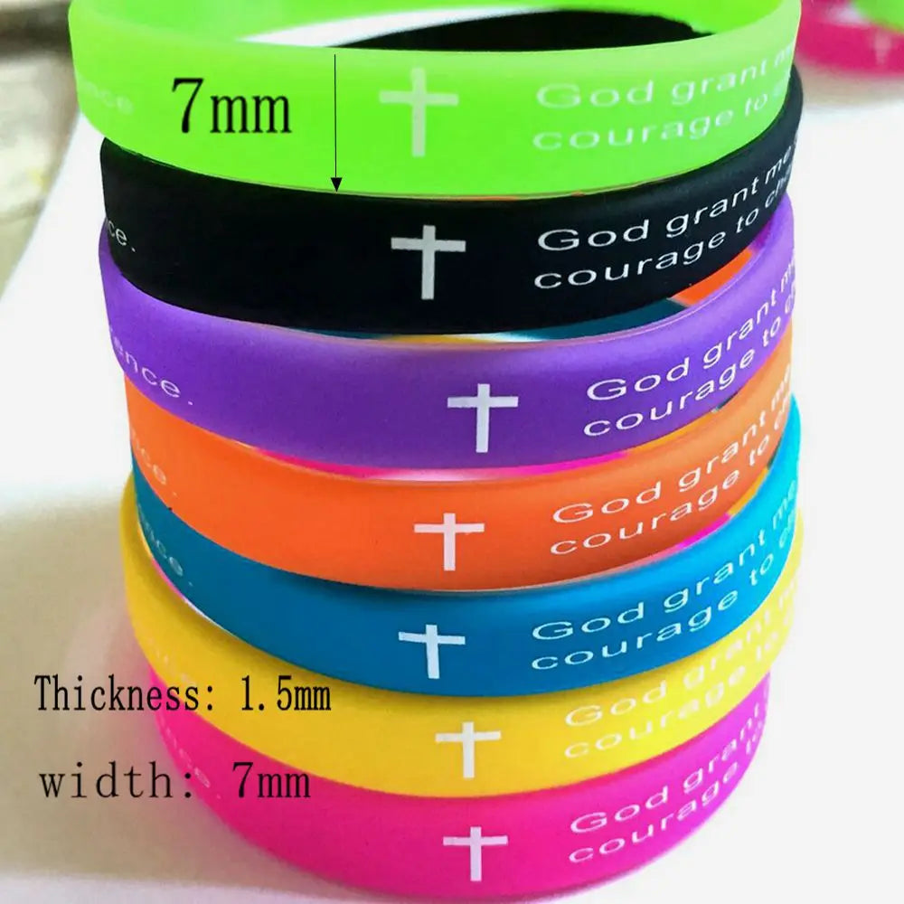 A stack of colorful silicone bracelets featuring a cross design and text on them.