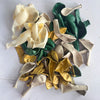 A collection of sage green and gold confetti balloons in various shapes and sizes.