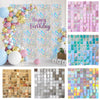 A display of various square panels with glitter and iridescent finishes in pink, blue, gold, and silver tones.