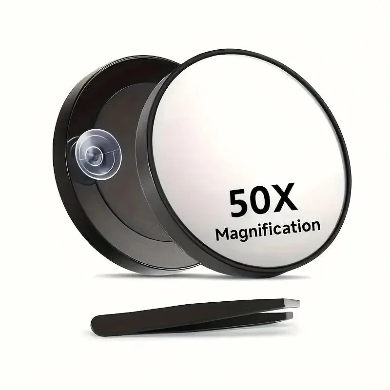 A black magnifying compact mirror with a circular lens and a suction cup is shown on a white background.