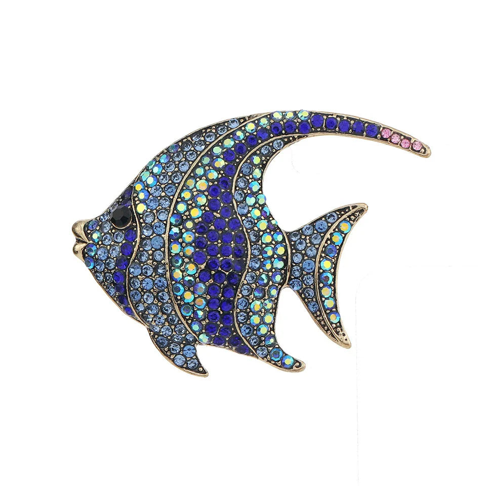 A vintage marine life brooch pin set shaped like a fish, featuring blue and yellow gemstones.