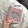 A pink photo album titled Collect with a heart design resting on white bedding.