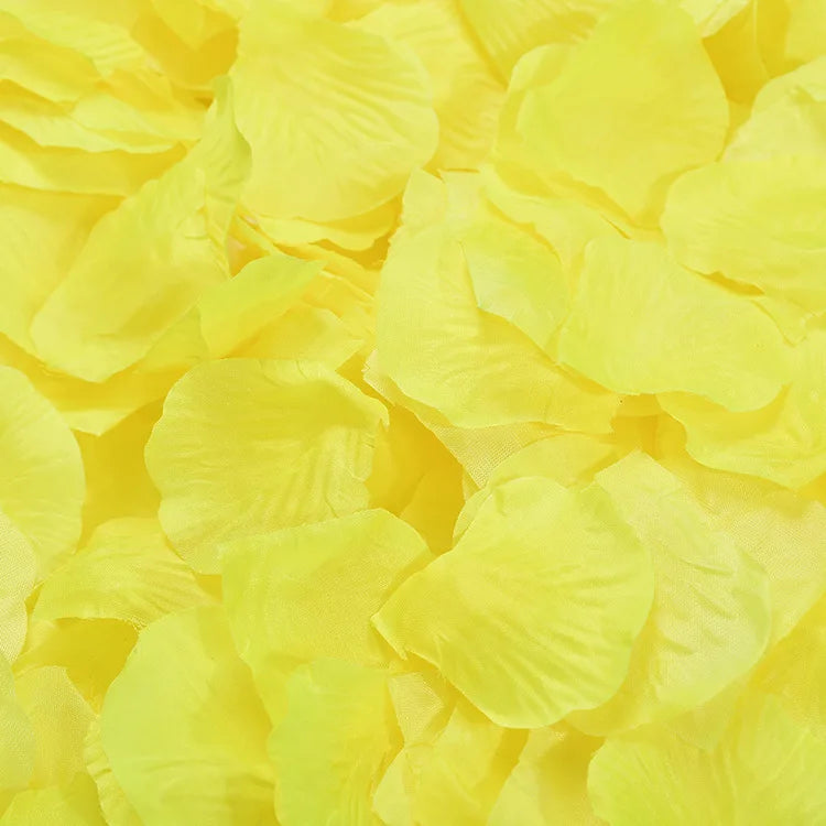 A pile of bright yellow artificial silk rose petals used for events.