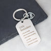 A silver stainless steel keychain with a heart charm engraved with five positive reminders.