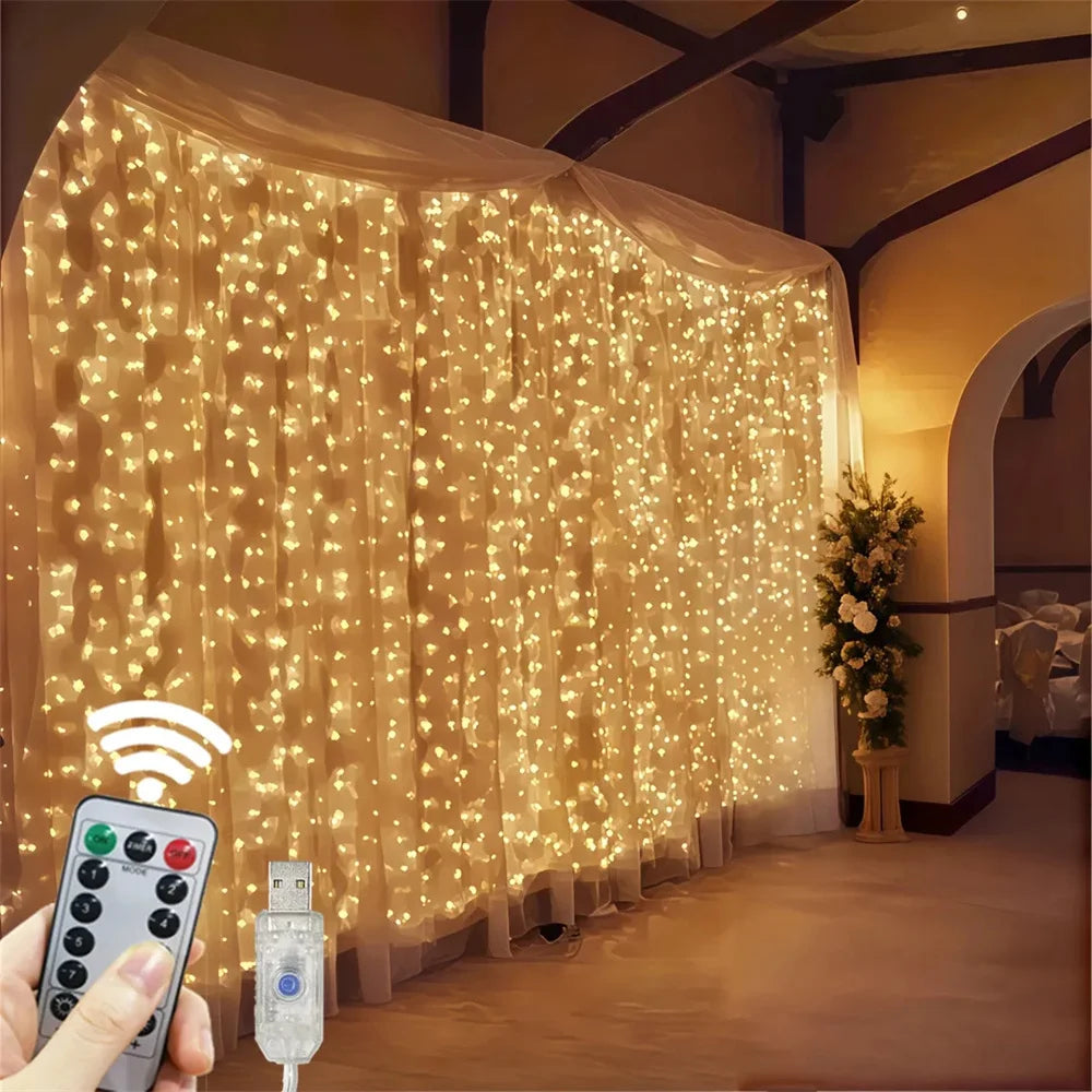 A hand holds a remote control device near a sheer curtain illuminated by warm fairy lights.