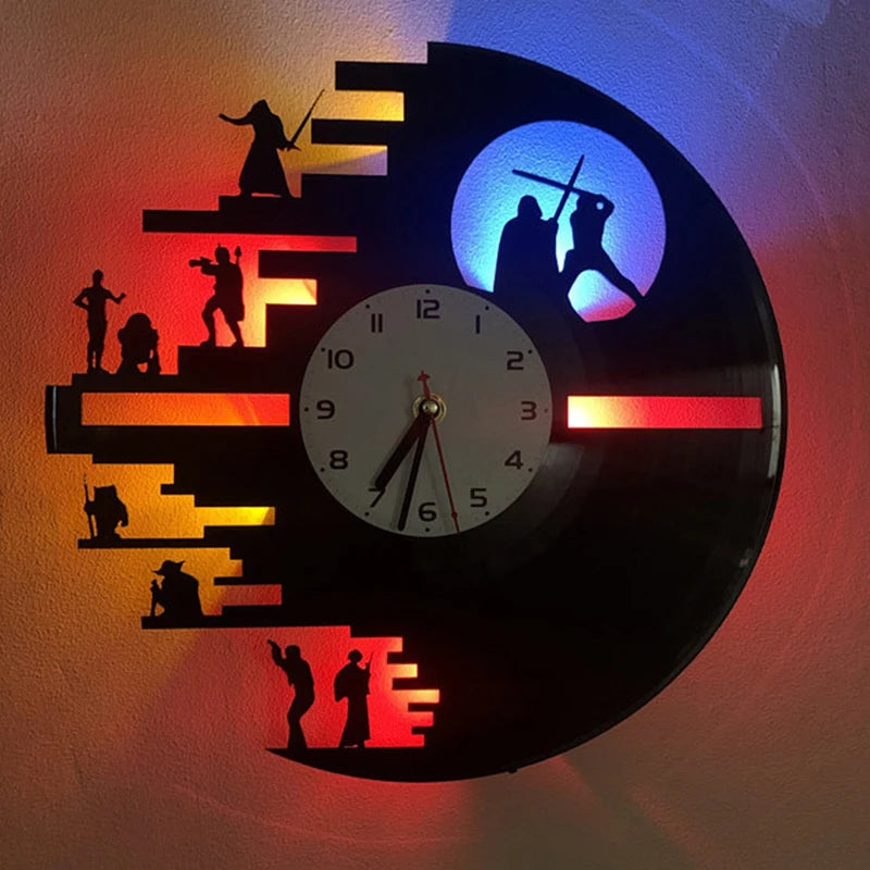 A wall lamp shaped like a vinyl record featuring silhouettes of people and colored LED lights.
