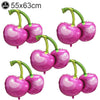 Five pink and green fruit-themed balloons resembling strawberries or cherries for party decorations