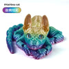 A colorful, textured silicone figurine of a headless cat head with large ears, featuring shades of blue and green.