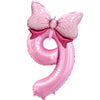 Pink foil balloon shaped like the number 9 with a pink bow decoration