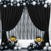 A black and silver draped backdrop curtain with a striped background and balloons.