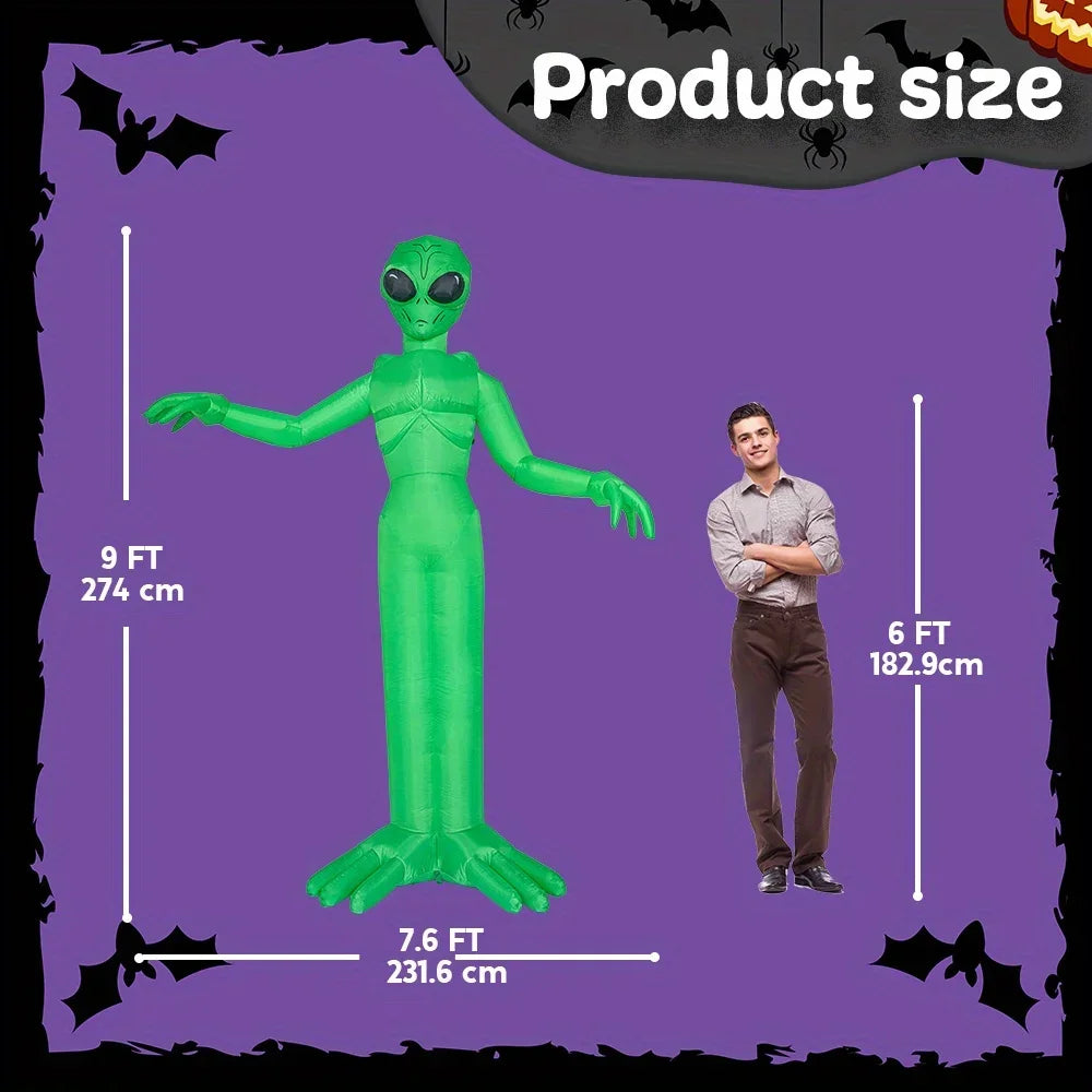 A tall, green alien inflatable decoration is shown next to a man for size comparison.
