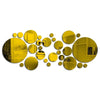 A collection of golden yellow acrylic mirror tiles arranged in a scattered, organic pattern.