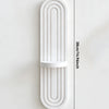 A white wooden wall shelf with a curved, arched design and vertical grooves.