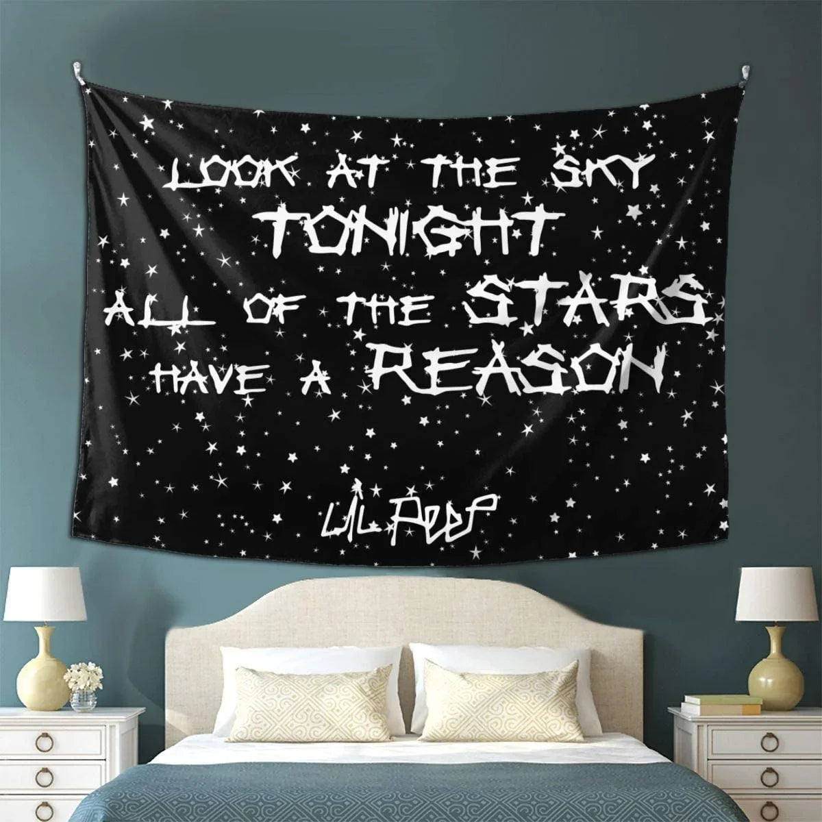 A black tapestry wall hanging featuring white text that reads Look at the sky tonight all of the stars have a reason.
