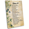 A vertical canvas wall art print featuring Spanish Psalm 91 text on a parchment background with green foliage.