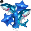 A blue shark foil balloon decoration with a toothy smile, used for an ocean-themed party.