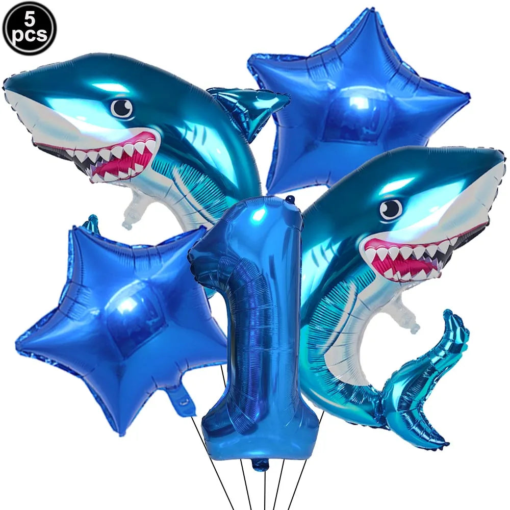 A blue shark foil balloon decoration with a toothy smile, used for an ocean-themed party.